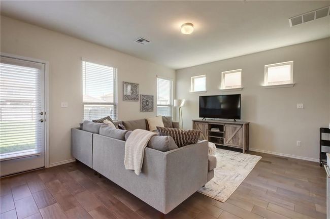 Living area featuring dark wood-type flooring and baseboards | Image 6