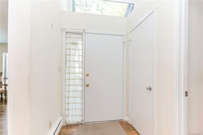 A skylight provides lots of sunlight in the entry. Door on right is closet. | Image 3