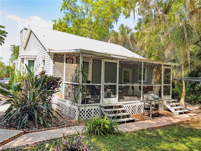 Back of property with a sunroom and a chimney | Image 20