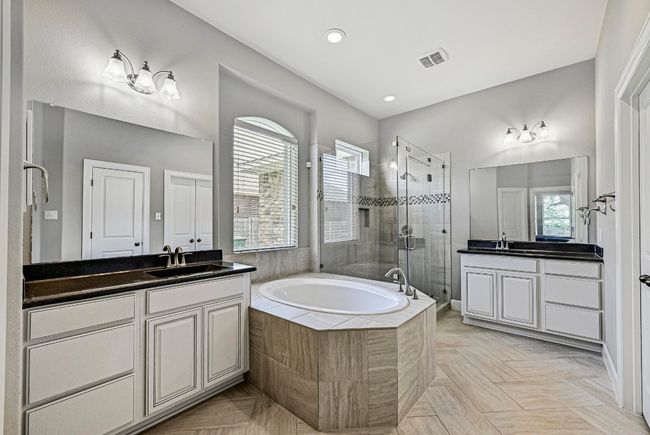Full bath with a shower stall, two vanities, a garden tub, and recessed lighting | Image 17
