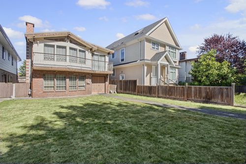Brick and stucco exterior with an upper-level balcony featuring metal railing | Card Image