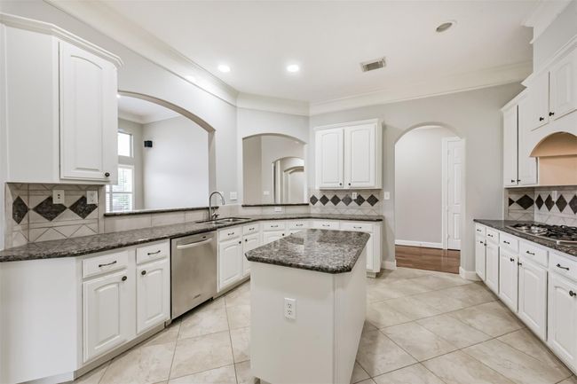 The very useful island with granite and cabinets. | Image 26