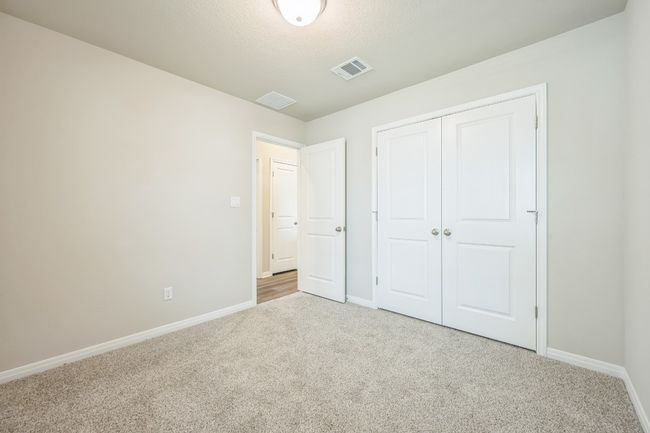 Unfurnished bedroom with carpet flooring and a closet | Image 11
