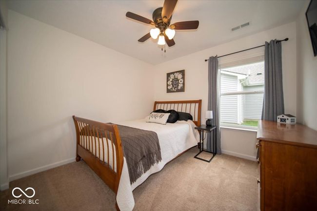 bedroom with carpet flooring, baseboards, and a ceiling fan | Image 20