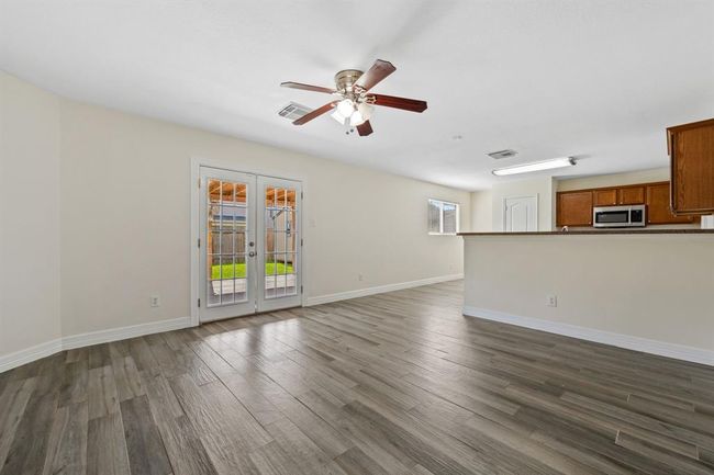 Open-concept layout between kitchen, dining, and living area. | Image 7