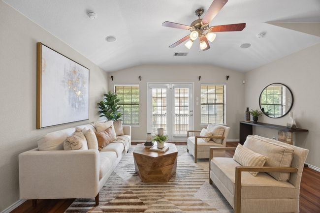 Living room featuring vinyl wood flooring, vaulted ceiling, and ceiling fan | Image 7