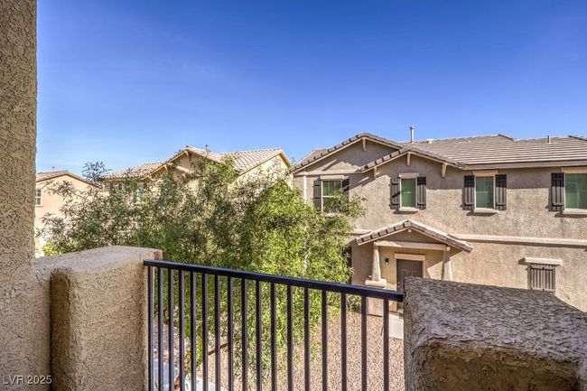 View of front of home with a balcony, a tiled roof, and stucco siding | Image 31