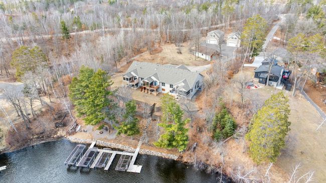 Aerial showing the 3 acres including the 3 unit townhome structure, 3 separate garages, 227ft lakeshore and shared waterfront. | Image 58