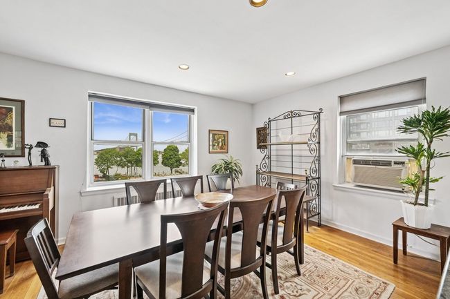 Dining room with light wood-type flooring, recessed lighting, cooling unit, and baseboards | Image 6