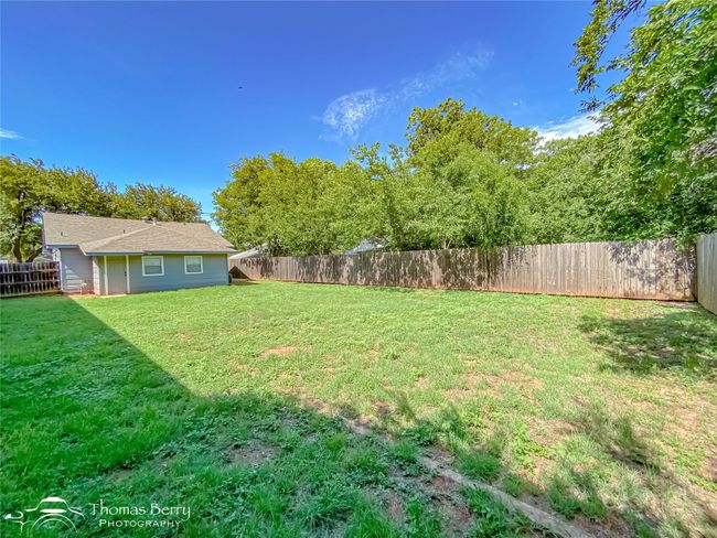 View of fenced backyard | Image 32