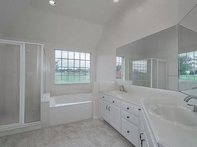 Bathroom featuring a stall shower, double vanity, a garden tub, and recessed lighting | Image 9