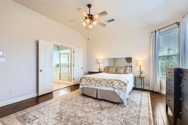 Bedroom featuring hardwood floor, vaulted ceiling, and ceiling fan | Image 15