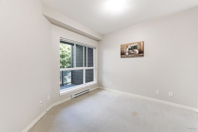 Carpeted spare room with baseboards and baseboard heating | Image 13