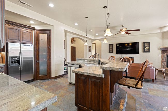 Kitchen with appliances with stainless steel finishes, stone tile flooring, arched walkways, ceiling fan, and recessed lighting | Image 34