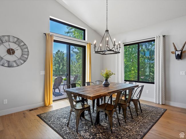 Dining room with a chandelier, plenty of natural light, baseboards, and high vaulted ceiling | Image 21