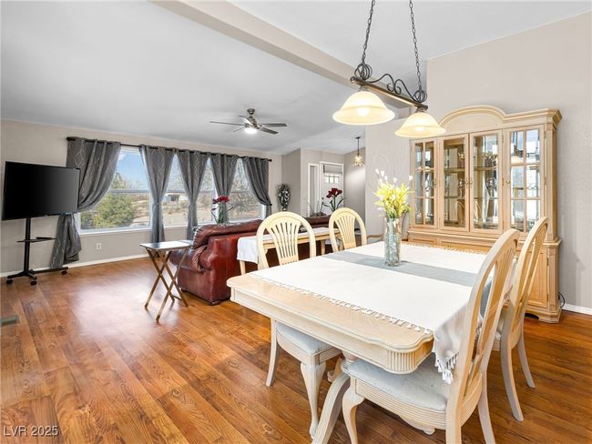 Dining area featuring a ceiling fan, wood finished floors, and baseboards | Image 19