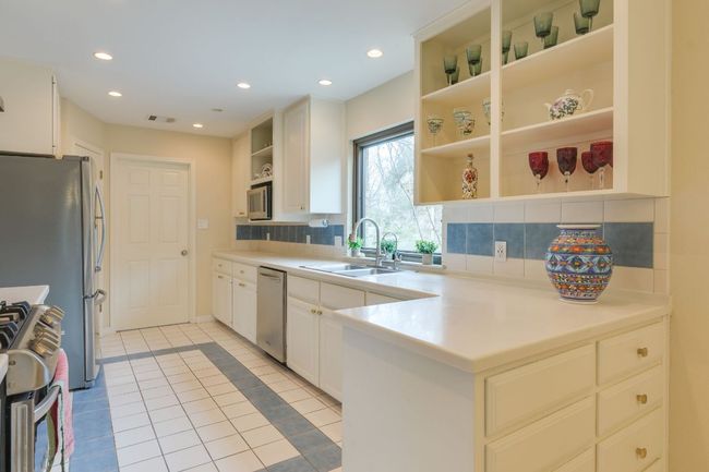 Kitchen with open shelves, stainless steel appliances, recessed lighting & beautiful picture window over sink | Image 6