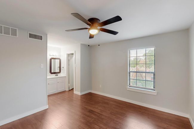 Unfurnished room featuring visible vents, ceiling fan, and dark wood-style flooring | Image 20