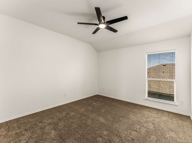 Spare room with dark colored carpet, a ceiling fan, and lofted ceiling | Image 32