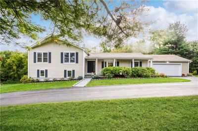 Front of house w/ circular driveway & garage | Image 1