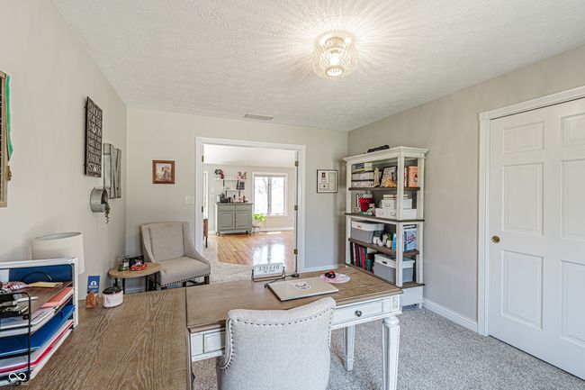 office with baseboards, visible vents, and a textured ceiling | Image 16