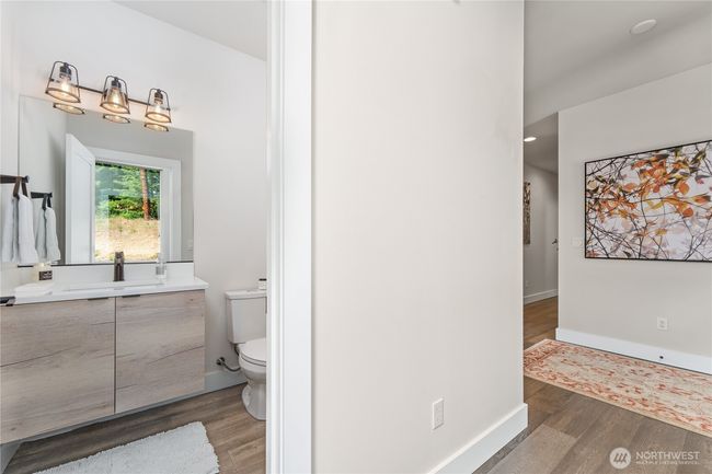 Guest bathroom with sleek cabinetry and designer finishes—perfectly blending form and function for added convenience and sophistication | Image 29