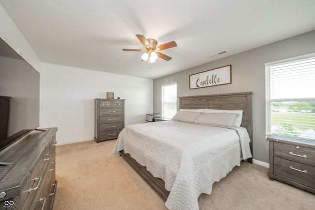 bedroom featuring light colored carpet, baseboards, and ceiling fan | Image 31