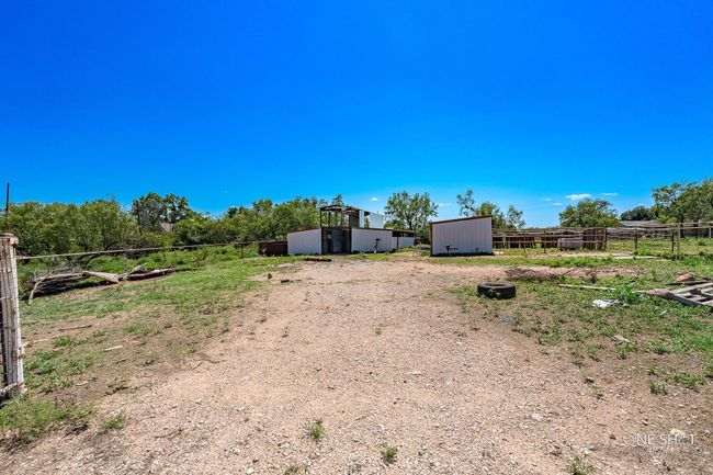 View of yard with a storage unit and a rural view | Image 4