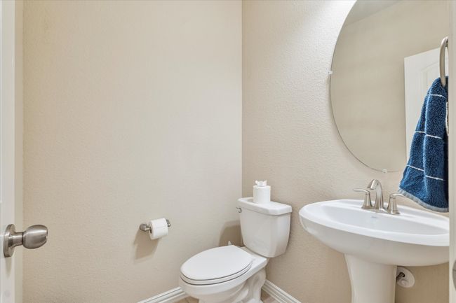 Half bathroom featuring toilet and baseboards | Image 6