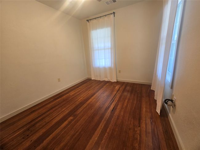 Spare room with dark wood finished floors and baseboards | Image 12
