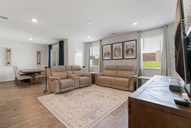 Living room featuring healthy amount of natural light, wood finished floors, and recessed lighting | Image 6