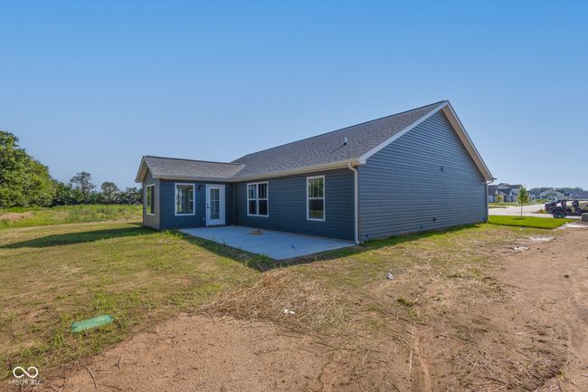 back of property with a patio, a yard, and a shingled roof | Image 4