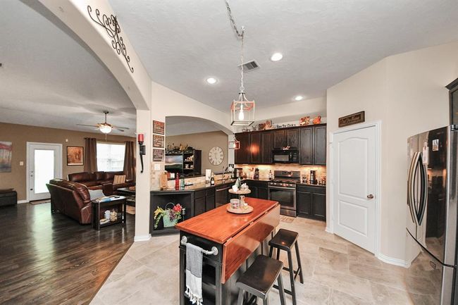 Open kitchen leads to laundry room and garage | Image 23