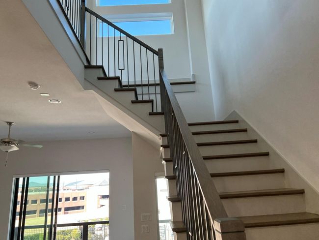 Stairway with a high ceiling, ceiling fan, and recessed lighting | Image 22