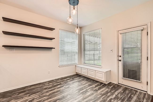 Unfurnished breakfast area with dark wood finished floors and baseboards | Image 15
