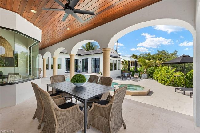 View of patio / terrace with outdoor dining area, a ceiling fan, and an in ground hot tub | Image 39