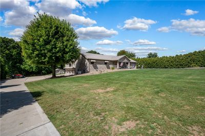 A 29' x 39' addition was added to the rear, left side of the home that added a massive Owner's Suite, complete with spacious bath and California-style, walkthrough closet, laundry room and a three-car integral garage. This was added in 2014 by Bachman once again. The main drive to the two-car attached garage is paved, and a concrete drive leads down to the three-car integral garage. A whole house generator makes power outages a breeze as it runs the whole home and switches over automatically. | Image 2