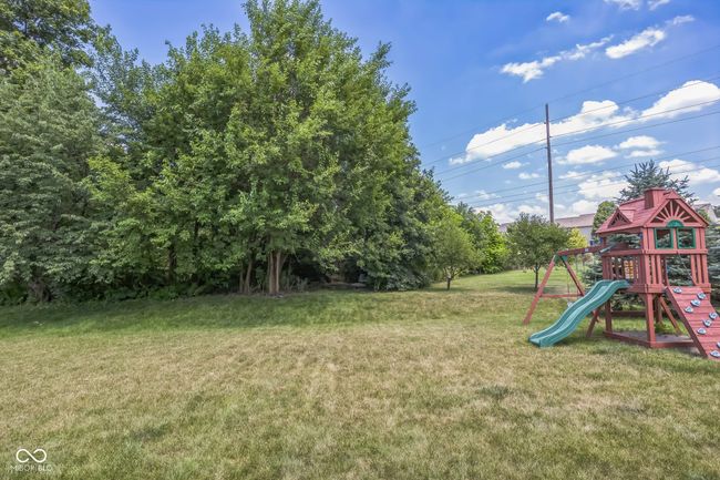 view of green lawn featuring a playground | Image 36