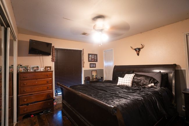 Bedroom with dark wood-style flooring and a ceiling fan | Image 20
