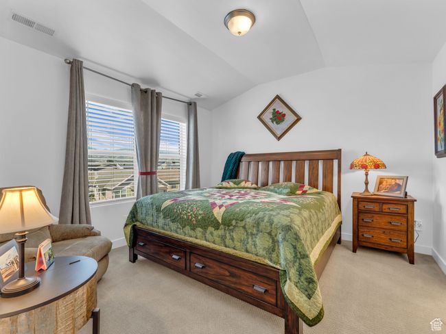 Owners Suite with light carpet and lofted ceiling | Image 27