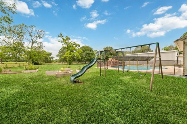 Tucked away on 1.5 serene acres in Manvel, this distinctive property is built for the way you want to live. The flexible floorpan allows between 4 to 6 bedrooms, 2.5 baths, a 2-car garage, in-ground pool, plus a 60'x30' insulated shop. | Image 44