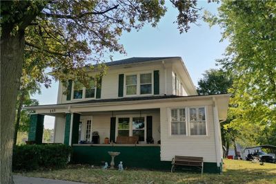 Back of property featuring a lawn and covered porch | Image 1