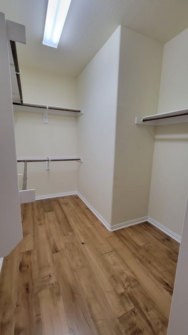 Walk in closet featuring wood finished floors | Image 16