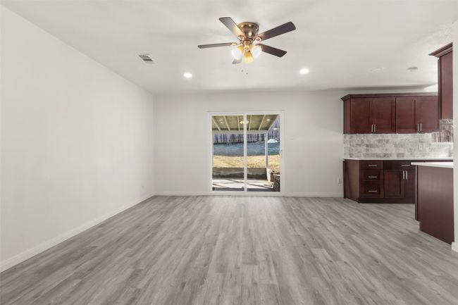 Unfurnished living room featuring light wood-type flooring and ceiling fan | Image 5