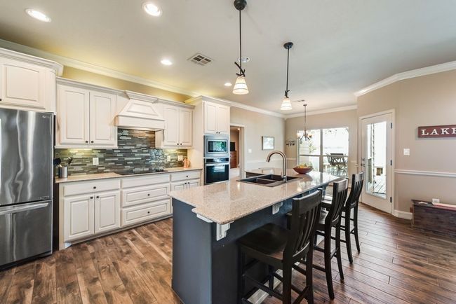 The home features lots of built in cabinetry to keep the kitchen area eat and tidy! | Image 12