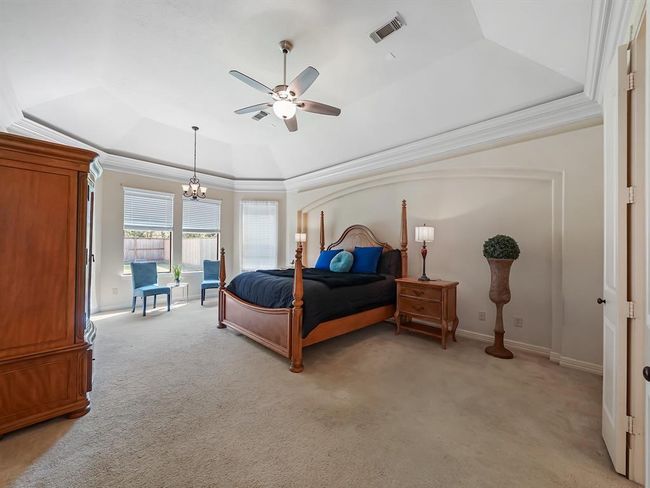 Spacious master bedroom featuring abundant natural light and soaring ceilings. | Image 23