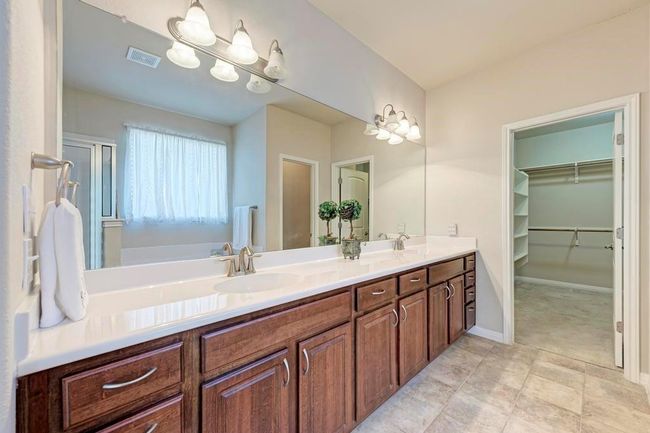 Full bathroom with double vanity and a walk in closet | Image 8