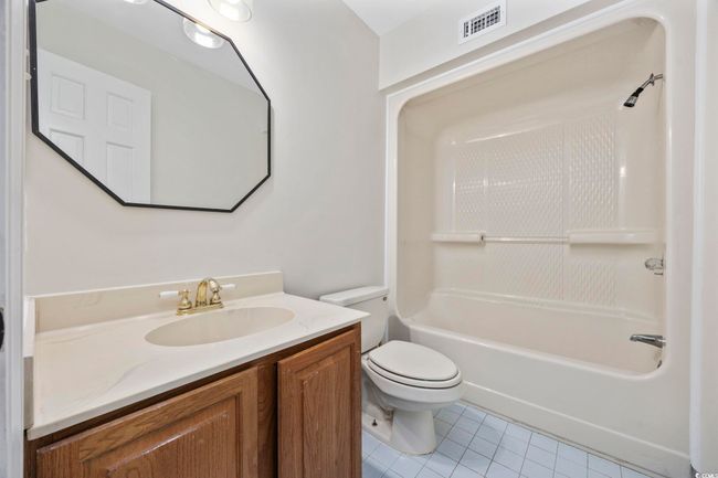 Full bathroom featuring tile patterned flooring, toilet, vanity, and shower / washtub combination | Image 28