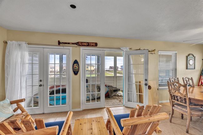 The double French doors open directly to the wrap around balcony. The area of the balcony shown in this photo has a view of the water. | Image 8