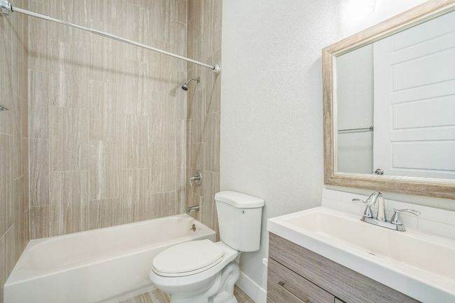 Full bath with toilet, shower combination, and vanity | Image 4